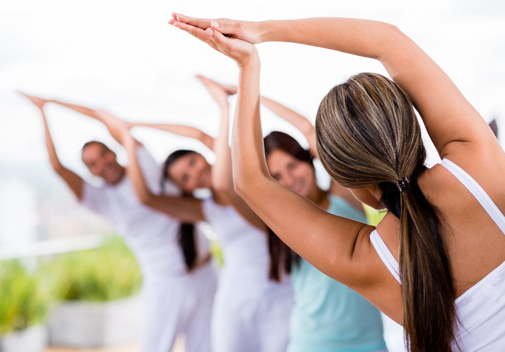 Group of people doing yoga and stretching